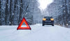 Warning triangle by car in snow