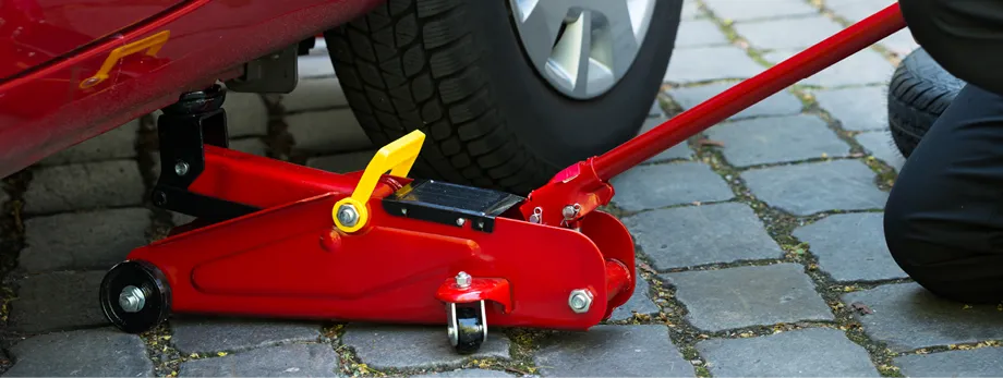 A car being lifted by a trolley jack