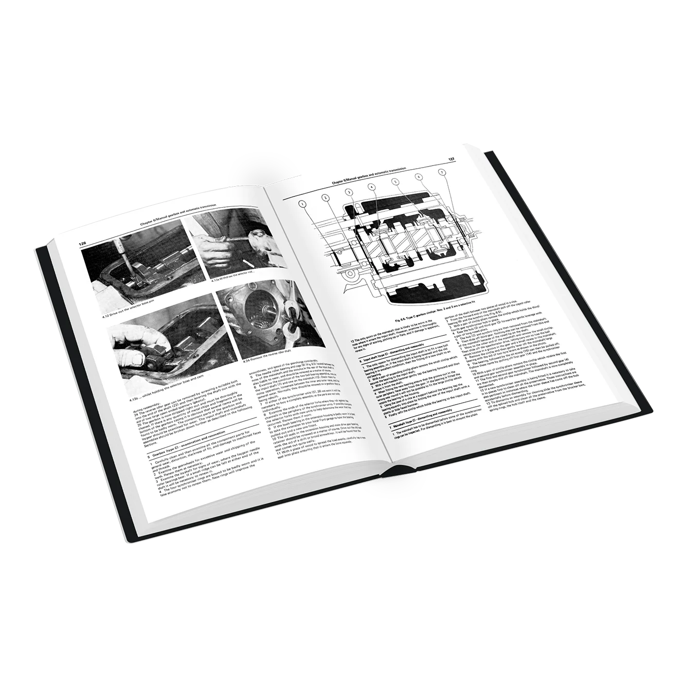 An open hardcover book showing printed pages with black-and-white photos and technical diagrams, photographed on a clean white background.
