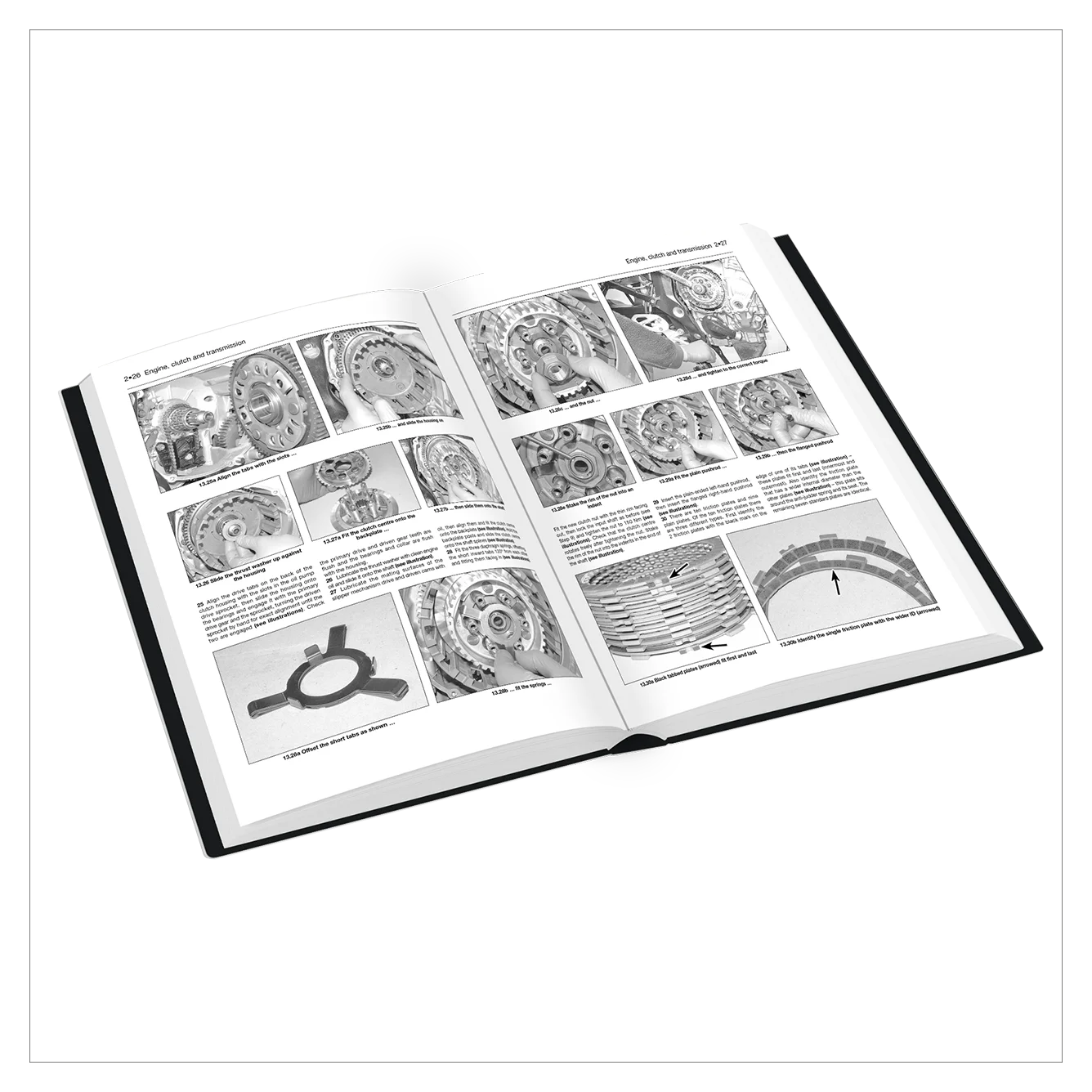 An open hardcover book displaying black-and-white technical pages with mechanical diagrams, parts illustrations, and descriptive text, photographed on a clean white background.